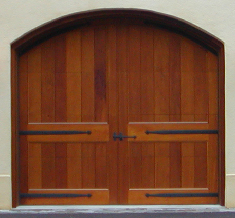 Custom barn-style door has a custom arch top