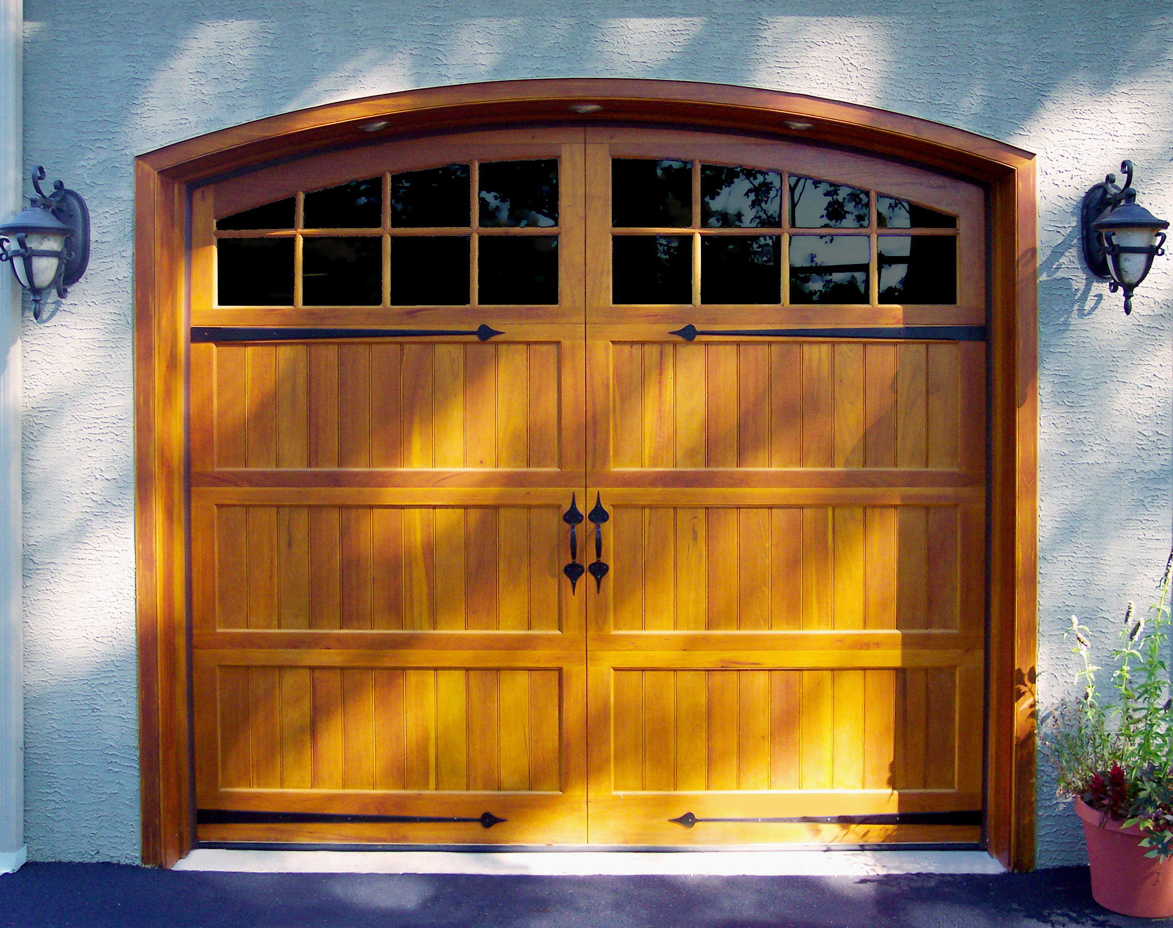 wood arched garage door with handles and glass top