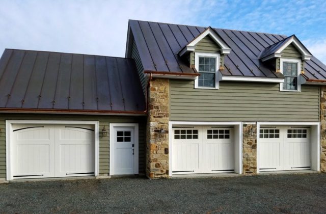 A detached garage shed with three garage doors