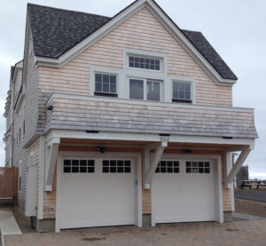 white 2 door garage on coastal home