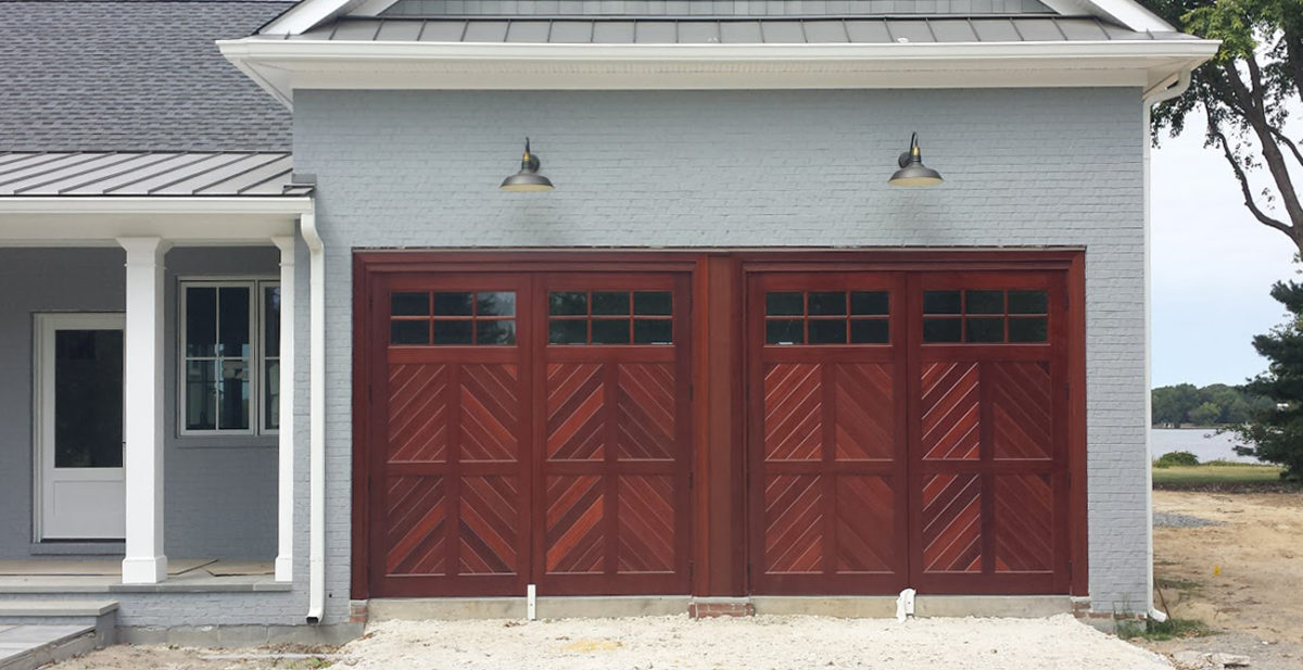 Artisan Medallion swing out garage door, shown in stained wood variety