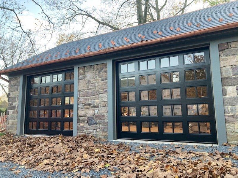 Black real wood garage door with window panes