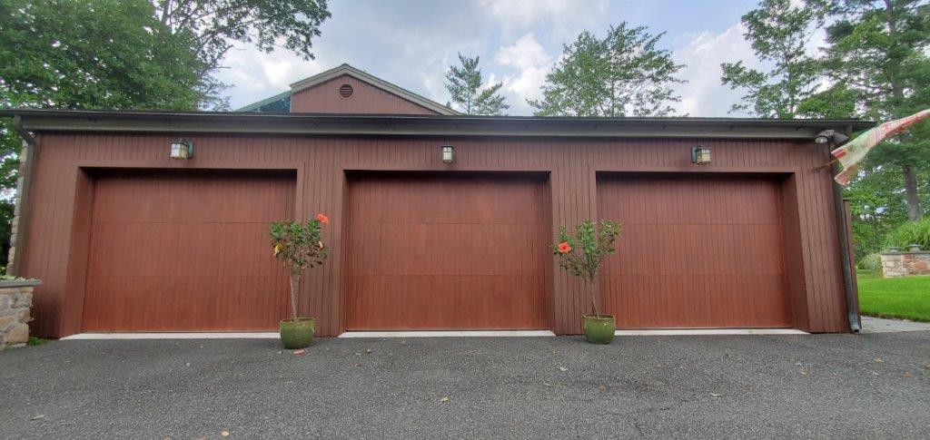 Three car garage with wood carriage style garage doors