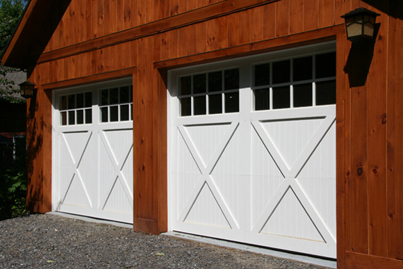 White Wood Carriage Style Garage Door On A Rustic Garage