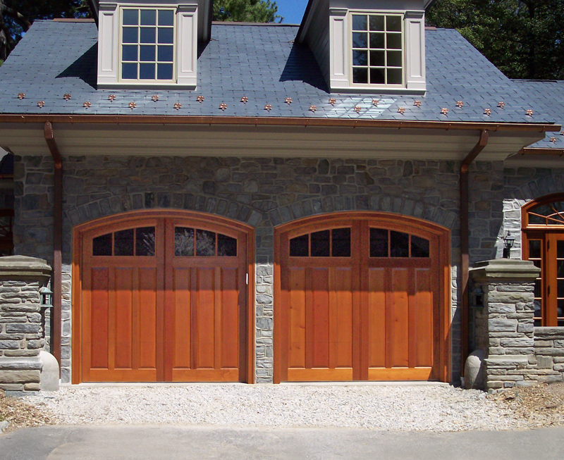 Two car stone garage with real wood garage doors installed