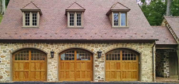 Arched Mahogany garage doors with cross rail trim boards
