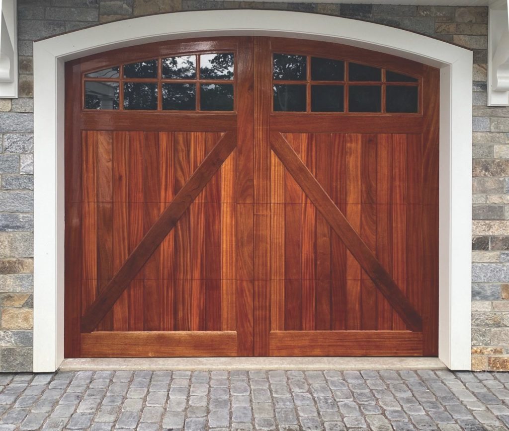 Stained real wood garage door with white trim