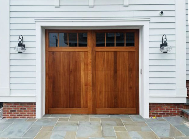 White vinyl garage with Artisan's Medallion real wood garage door