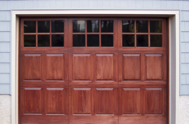 Square garage door windows on a wooden garage door