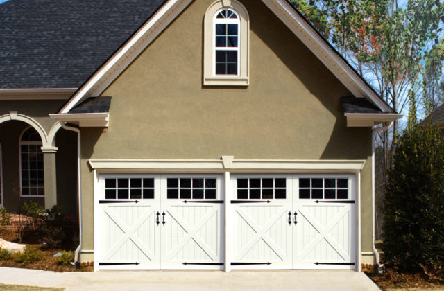 Symphony from Artisan Custom Doorworks, a white vinyl garage door on a beige garage
