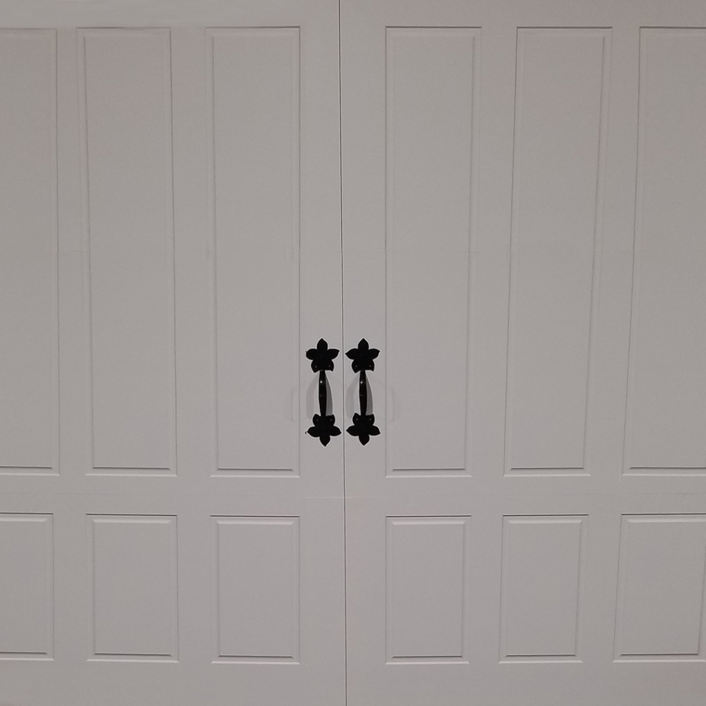 White vinyl garage door with flower door handles