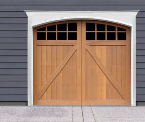 Brown swing out wooden carriage garage door with windows and z panel bucks