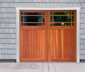 Brown wooden swing out carriage garage door with two windows