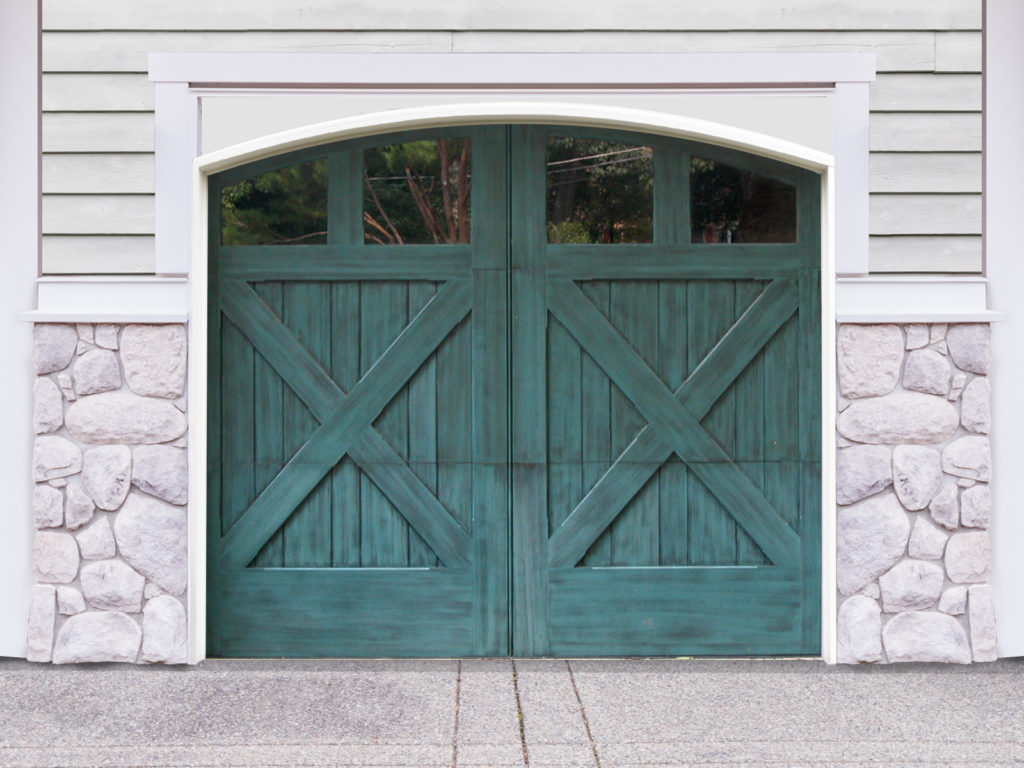 Teal arched swing out garage door with four windows and cross bucks on white vinyl and stone garage