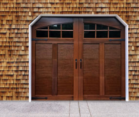 Mahogany faux wood carriage garage door with two windows and door handles