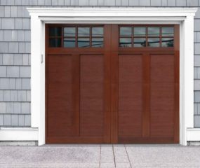 Mahogany stained faux wood swing out garage door with two windows
