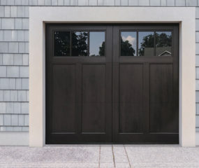 Walnut stained faux wood carriage garage door with two windows