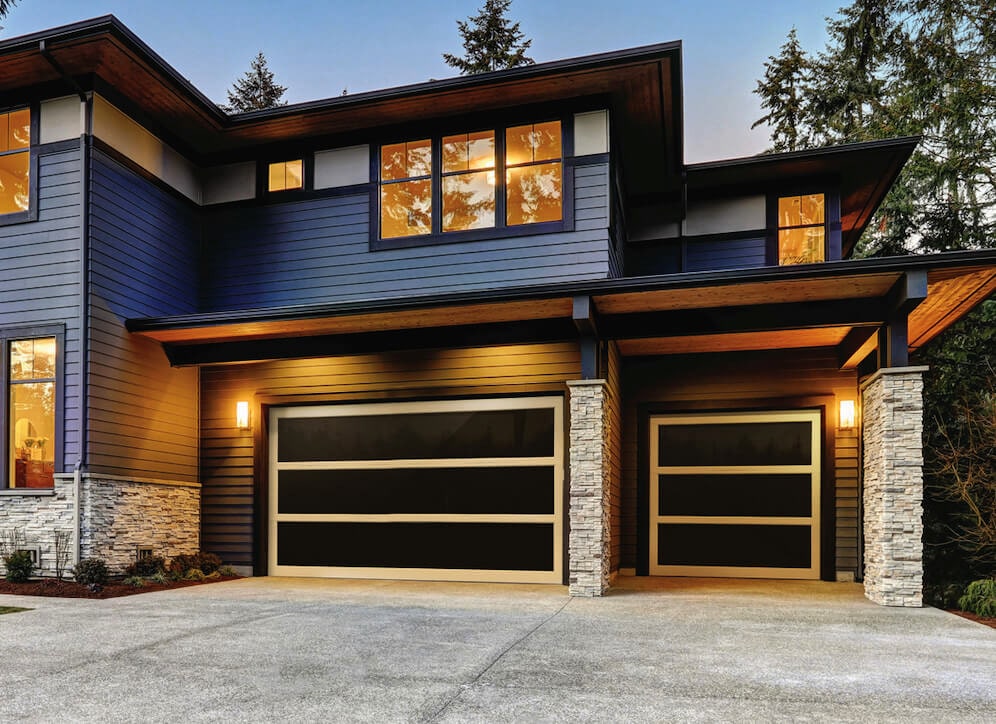 A modern black and gold garage door that is part of the Panorama garage door series 