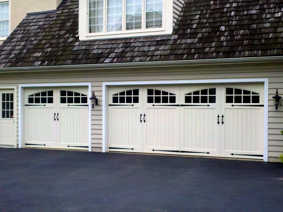 a classic white carriage garage door that is a part of the Symphony door series