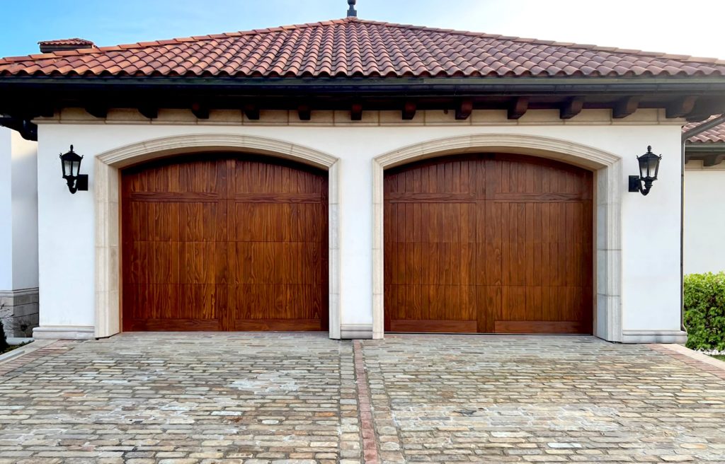 double wood garage doors with two small lights on either side