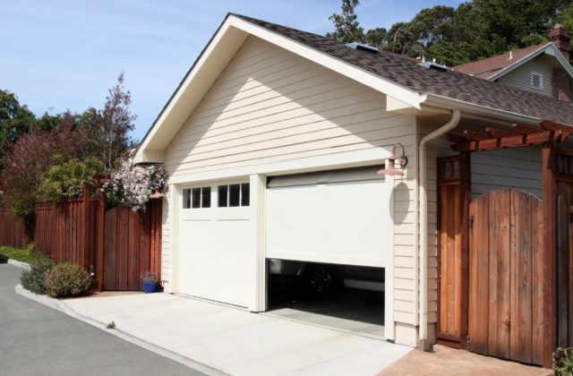 A garage door that's half open and exposing what's inside.