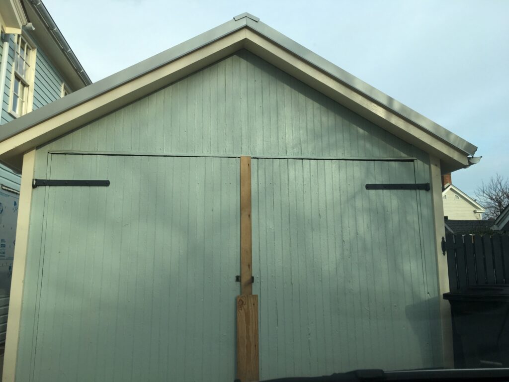 Before & After: image of worn out, old garage door on a detached garage