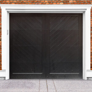 Dark brown wooden garage door with no windows on brick garage