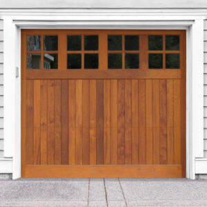 Brown wooden garage door with four windows on gray vinyl garage