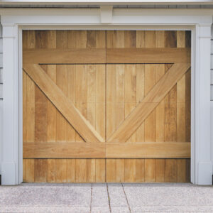 Natural brown wood swing out garage door with v bucks on gray wood garage