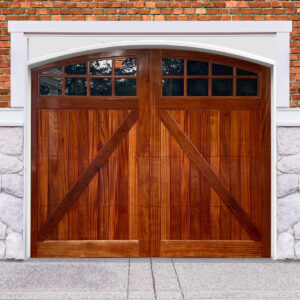 Brown arched swing out garage door with v bucks and two windows on brick and stone garage