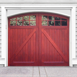Red stained arched swing out wooden carriage garage door with two windows and z buck panels