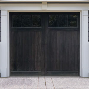 Black stained wooden carriage garage door with two windows