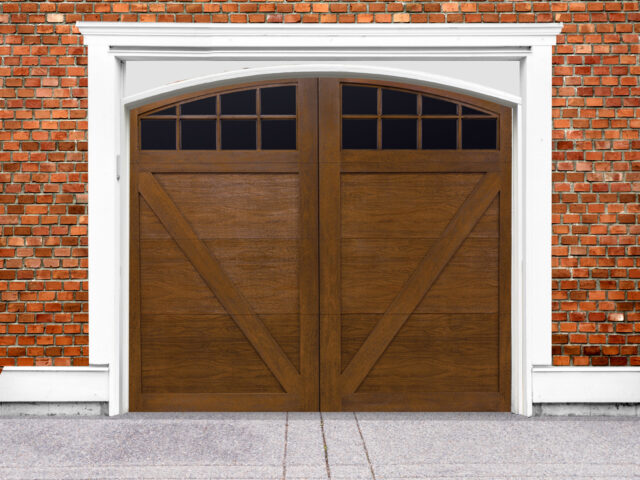 Ash stain finish faux wood garage door with v buck panels and two windows