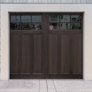 Walnut stained faux wood carriage garage door with six panels and two windows