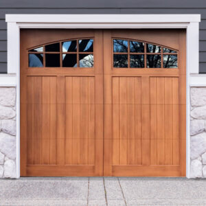 Golden oak stained faux wood carriage garage door with two windows