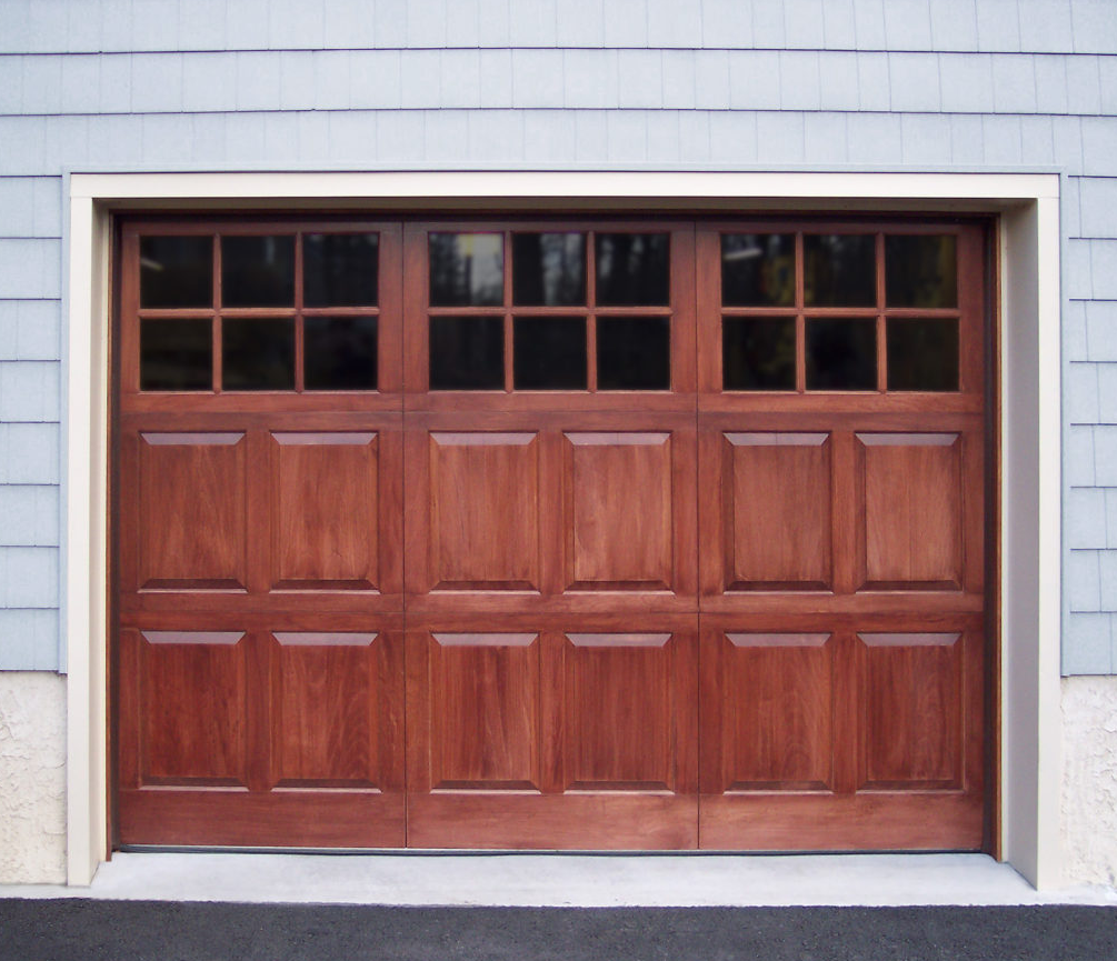 Square garage door windows on a wooden garage door