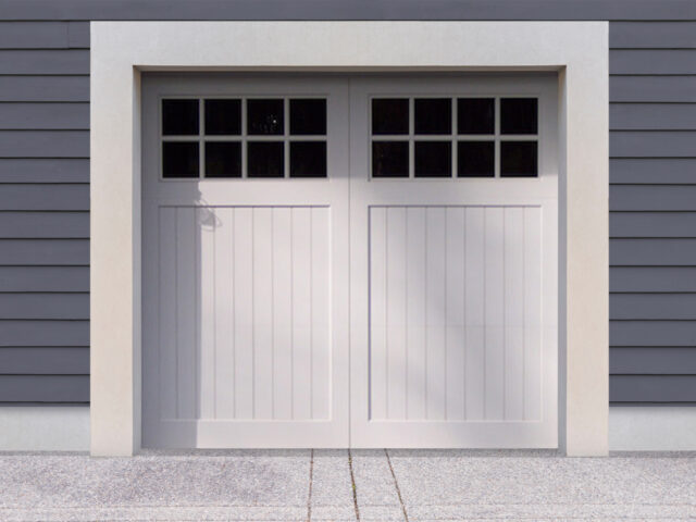 White vinyl carriage house garage door with two panels and windows