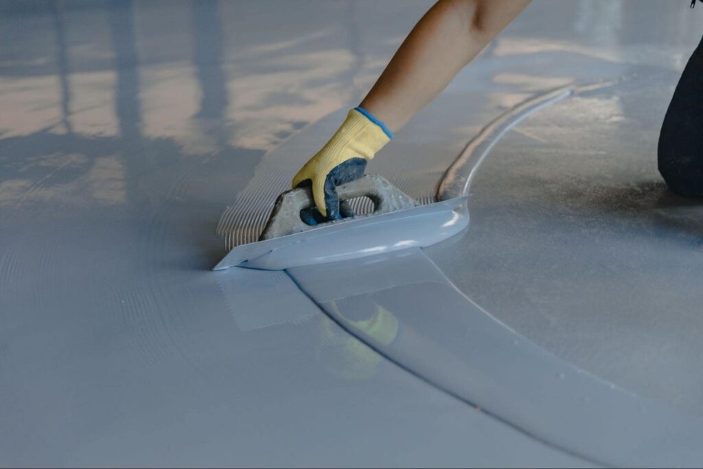 Someone applying new garage epoxy flooring